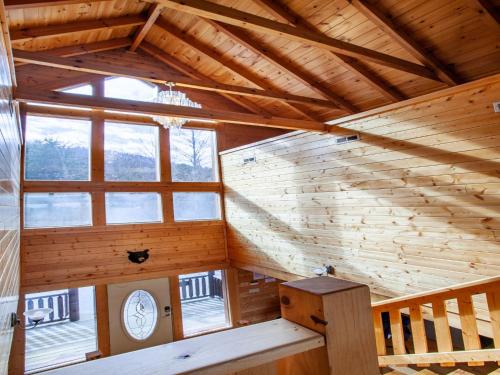 an attic room with a wooden ceiling and windows at Copper Top - Stunning Views, and Hot Tub in Sevierville