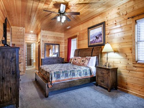 a bedroom with a bed and a ceiling fan at Copper Top - Stunning Views, and Hot Tub in Sevierville