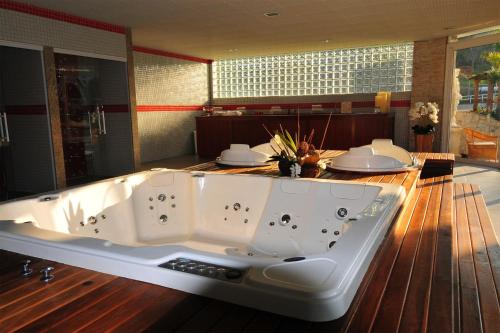 a large white bath tub sitting in a room at Vassouras Eco Resort in Vassouras