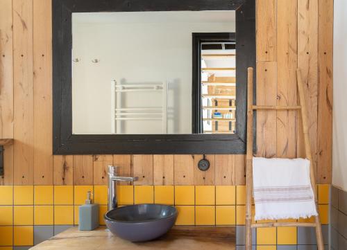 a bathroom with a bowl sink and a mirror at Kazbegi cabins in Stepantsminda