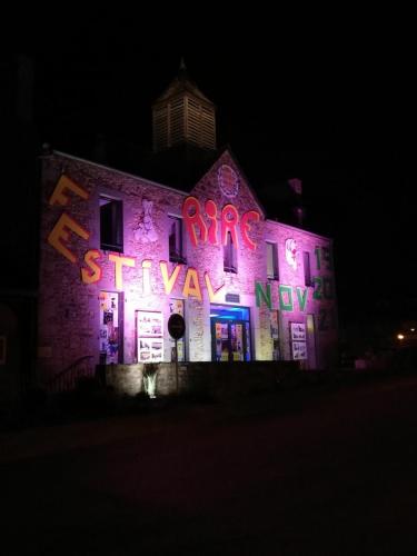 a lit up building with neon signs on it at LE COCON de MATIGNON Gîte 4 étoiles 5 kms mer in Matignon
