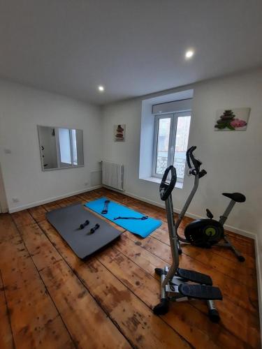 a room with a gym with a treadmill and exercise bike at LE COCON de MATIGNON Gîte 4 étoiles 5 kms mer in Matignon