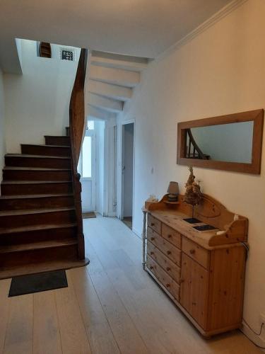 um quarto com uma escada e uma cómoda com um espelho em LE COCON de MATIGNON Gîte 4 étoiles 5 kms mer em Matignon