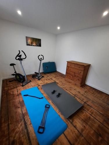 a room with two mats and exercise equipment on a wooden floor at LE COCON de MATIGNON Gîte 4 étoiles 5 kms mer in Matignon
