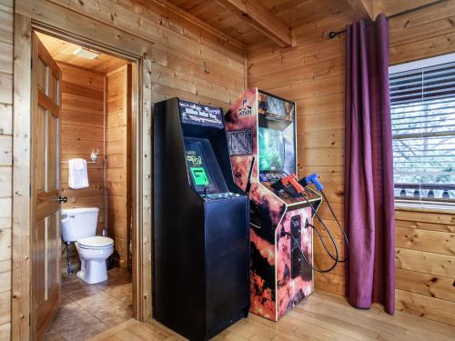a room with a video game machine in a room at Million Dollar View - Hot Tub, and Sauna! in Sevierville