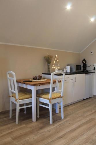 a kitchen with a table and two chairs and a counter at La Veraison in Malmedy