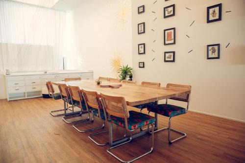 a dining room with a wooden table and chairs at STAY OPEN Venice Beach in Los Angeles