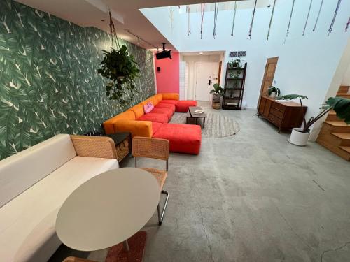 a living room with a couch and a table and chairs at STAY OPEN Venice Beach in Los Angeles
