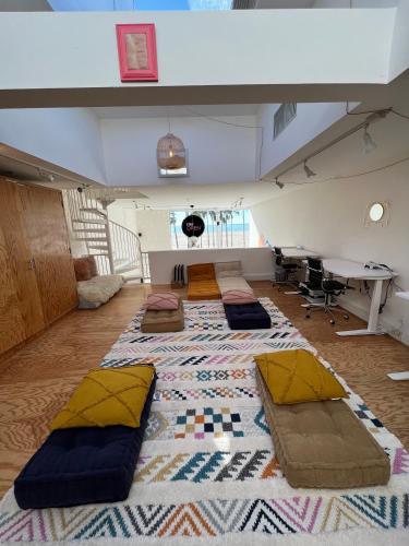 an attic room with several pillows on the floor at STAY OPEN Venice Beach in Los Angeles