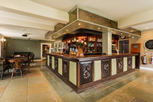 um bar num pub com uma mesa e cadeiras em The Percy Arms em Chatton