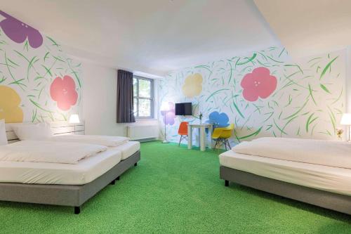 Postel nebo postele na pokoji v ubytování Flowers Hotel Münster