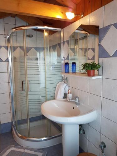 a bathroom with a sink and a shower at Villasabella in Laganas