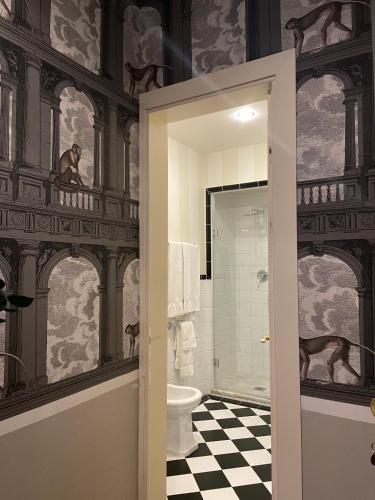 a bathroom with a toilet and a wall mural at Residenza dei Pucci in Florence