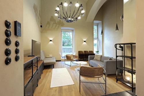 ein Wohnzimmer mit einem Sofa und einem Kronleuchter in der Unterkunft American Loft in the Heart of Prague in Prag