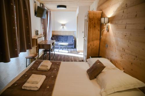 a bedroom with a large bed with a wooden wall at Le Dahu in Chamonix