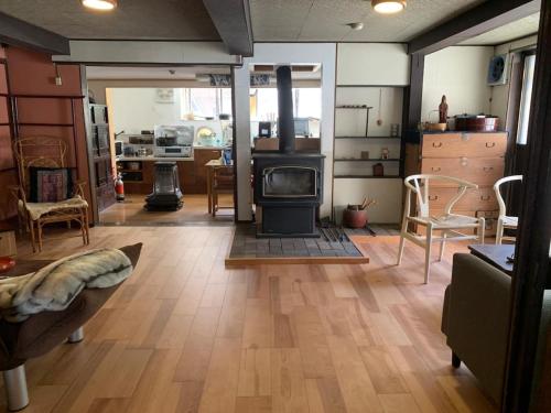 a living room with a wood burning stove in it at Arimaya - Vacation STAY 14255v in Mitsumata