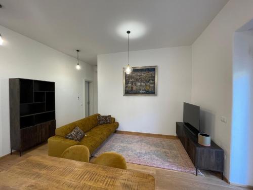 a living room with a couch and a tv at Ipavčeva vila in Maribor