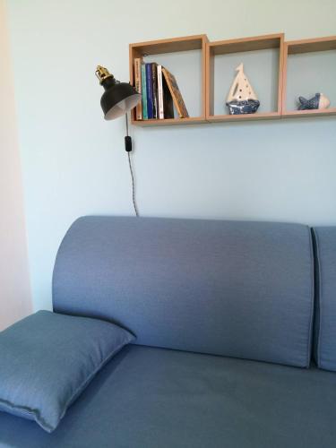 a bed with a lamp and a shelf with books at Casa Magellano, lido conchiglie -Gallipoli-Salento in Lido Conchiglie