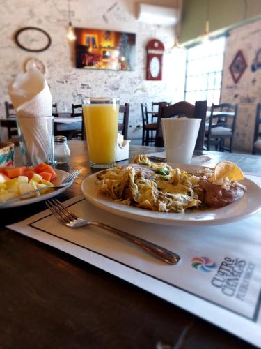 a table with a plate of food and a drink at Hotel Plaza Cuatro Ciénegas in Cuatrociénegas de Carranza