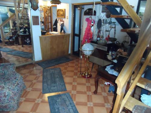 a living room with a staircase and a dressing room at Hostal Español Coyhaique in Coihaique