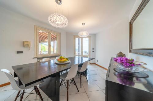 a dining room with a black table and chairs at Villa Liana in Vinci