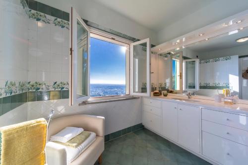 a bathroom with two sinks and a large window at Villa Liana in Vinci
