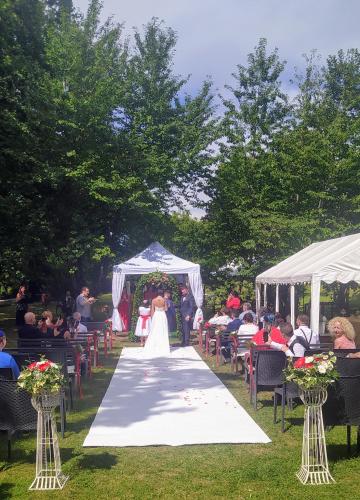 a bride and groom walking down the aisle at their wedding at "La Selvetta" bed and breakfast in Buguggiate