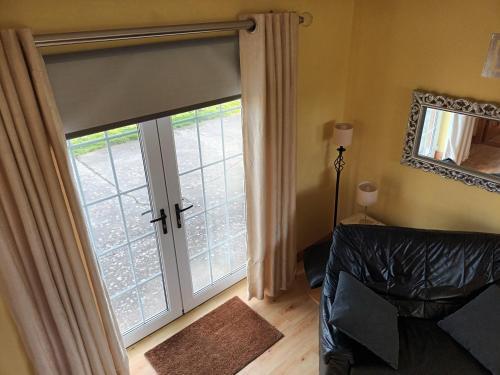 a living room with a sliding glass door at Rathgillen Mews in Nobber
