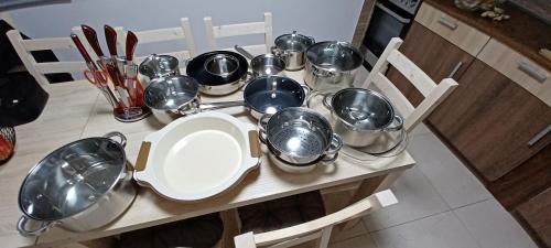 a table with a bunch of pots and pans on it at Chata U dědka in Prostřední Bečva