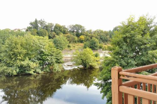 a view of a river with a bridge and trees at Lovely T2 - Proche du CHU LIMOGES in Isle