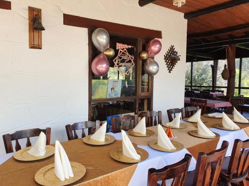 a long table with hats and balloons on it at Hacienda Buenos Aires en Iza in Iza