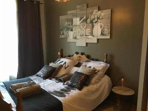 a bedroom with a bed with pillows on it at gîte le couraduque avec bain nordique et sauna en pleine montagne in Arrens-Marsous