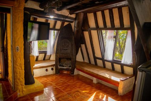 a room with two benches in a room with windows at Hacienda Buenos Aires en Iza in Iza