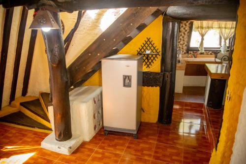 a small refrigerator in the middle of a room at Hacienda Buenos Aires en Iza in Iza