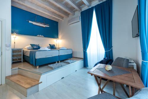 a bedroom with a bed with a blue wall at Nautica Room 1 - Old Town in Dubrovnik