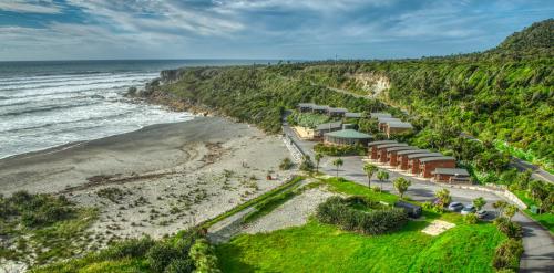 an aerial view of a resort on the beach at Scenic Hotel Punakaiki in Punakaiki