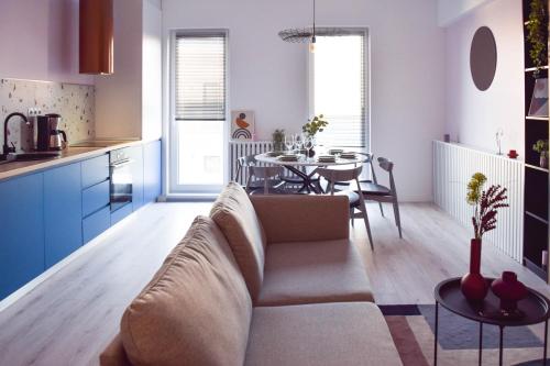 a living room and kitchen with a couch and a table at Veles Apartments in Sibiu