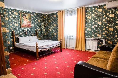 a bedroom with a bed and a red carpet at Hotel Akvamarin in Leninogorsk