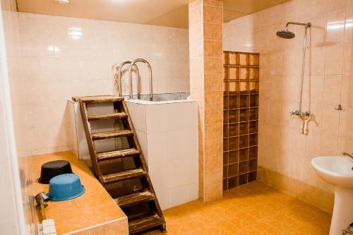 a bathroom with a sink and a shower and a toilet at Hotel Akvamarin in Leninogorsk