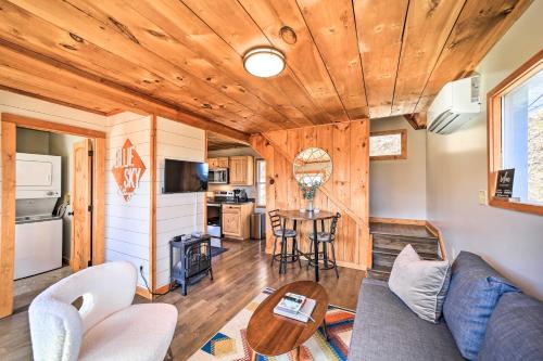 a living room with a couch and a table at Blue Sky Cottage Romantic Retreat with Mtn Views! in Canton