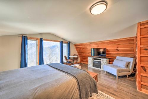 a bedroom with a bed and a tv and a chair at Blue Sky Cottage Romantic Retreat with Mtn Views! in Canton