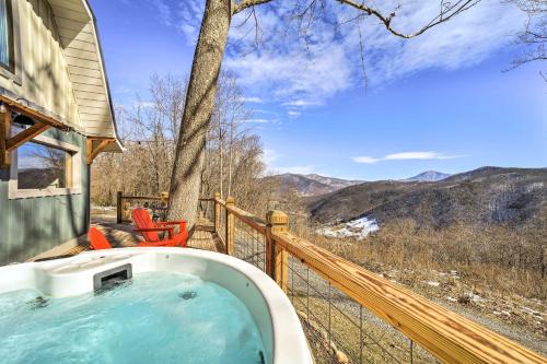 a hot tub on a deck with a view of the mountains at Blue Sky Cottage Romantic Retreat with Mtn Views! in Canton