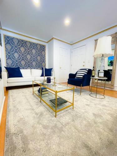 a living room with a couch and a table at Luxurious Room near LaGuardia & JFK in Corona