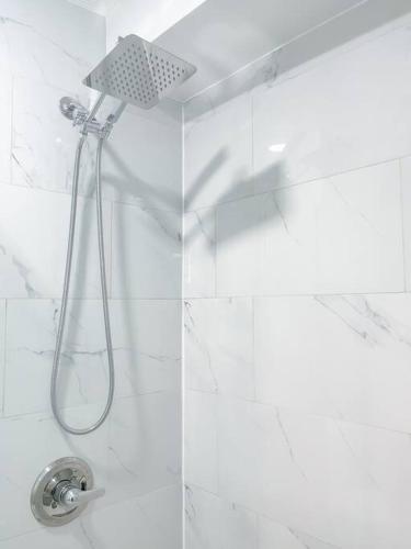 a shower with a shower head in a bathroom at Luxurious Room near LaGuardia & JFK in Corona