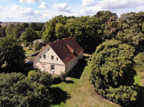 an aerial view of a house in the middle of trees at Altes Pastorat Schwichtenberg in Borrentin