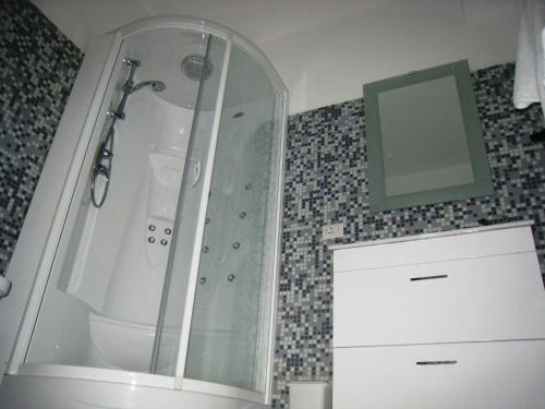 a bathroom with a shower, sink, and tub at B&B La Terrazza Sul Mare Taormina in Taormina