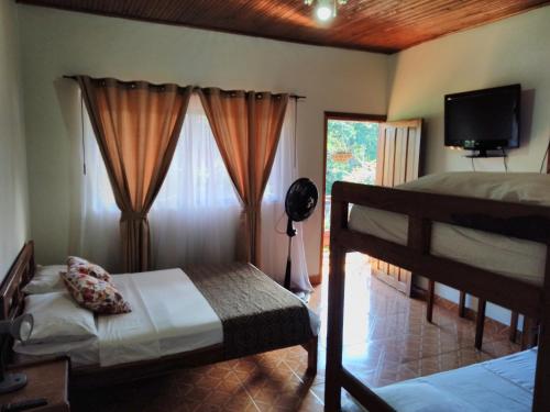 a bedroom with two bunk beds and a television at HOTEL MORGAN in Guaduas