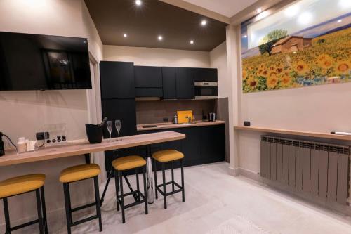 a kitchen with a counter and stools in it at Domus Aurelia in Rome
