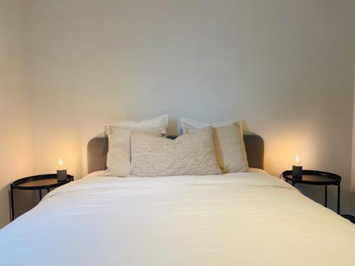 a bedroom with a bed with two candles on tables at Your Room with A View Bolderberg in Heusden - Zolder