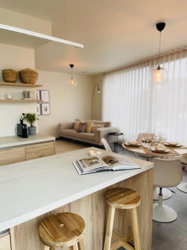 a kitchen and living room with a table and stools at Your Room with A View Bolderberg in Heusden - Zolder